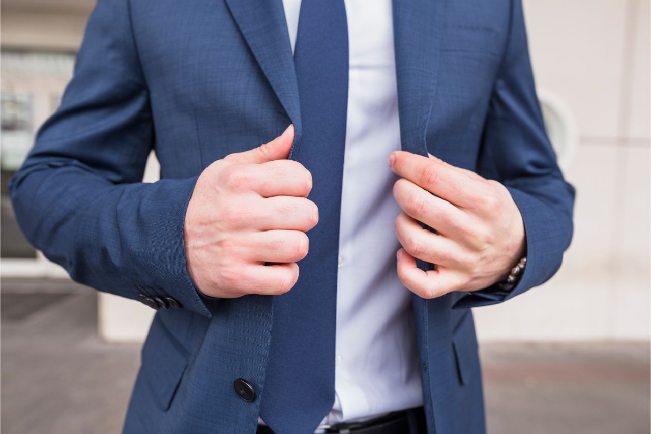 A businessman putting on a blazer