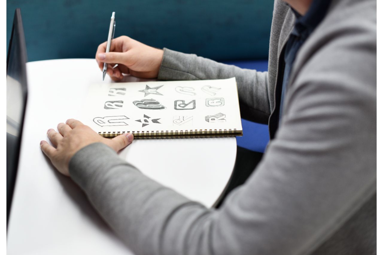 A man drawing different logos