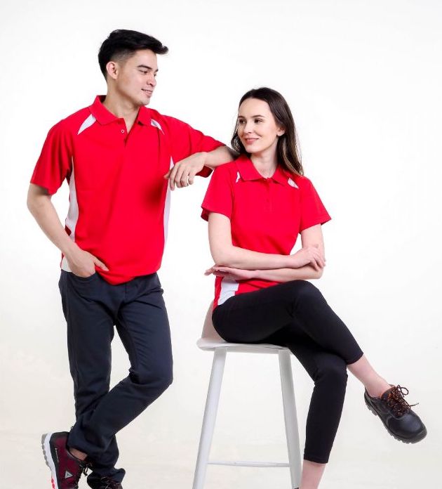 A man and a woman wearing polo shirt uniforms by Dels Apparel