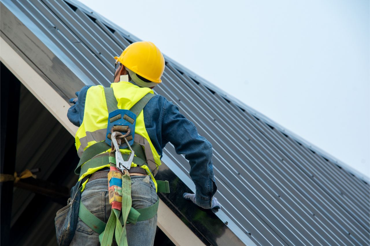 A man  installing metal structure on top roof